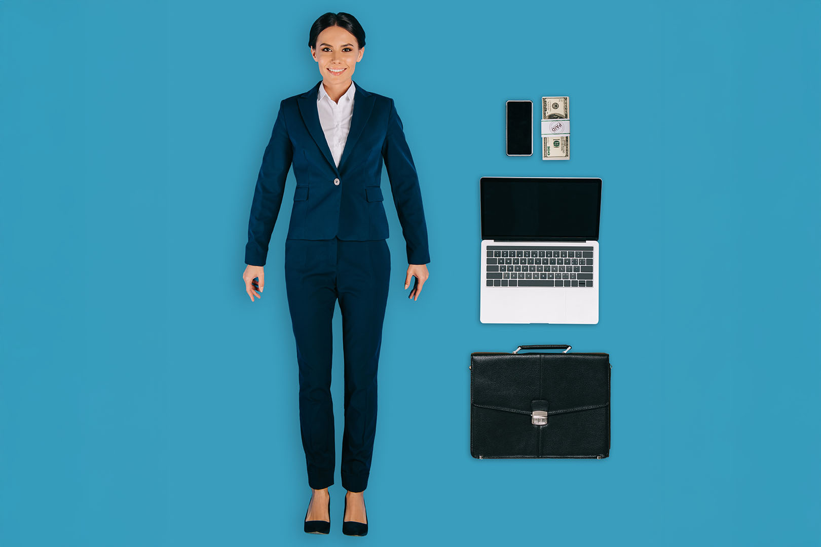 top view of businesswoman with laptop, briefcase, money and smar